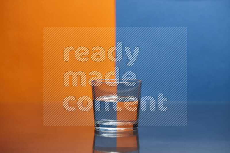 The image features a clear glassware filled with water, set against orange and blue background