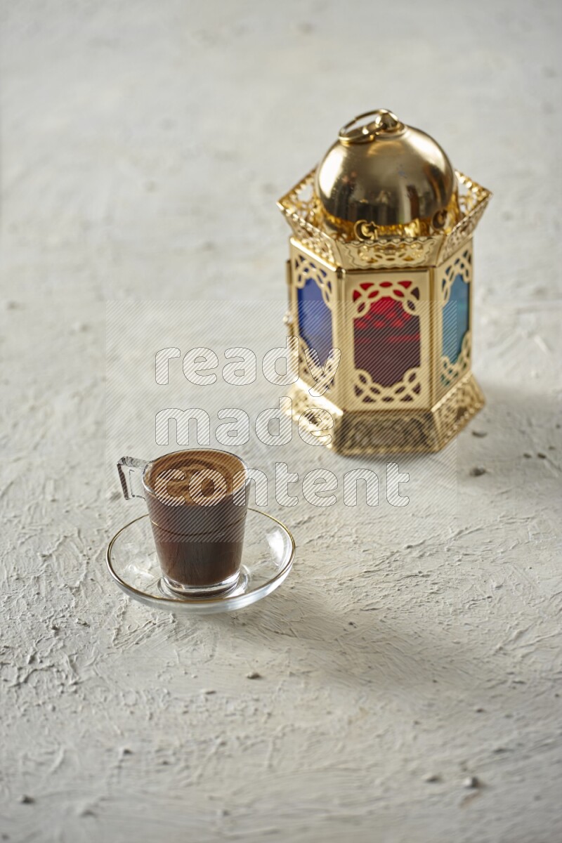 A golden lantern with different drinks, dates, nuts, prayer beads and quran on textured white background