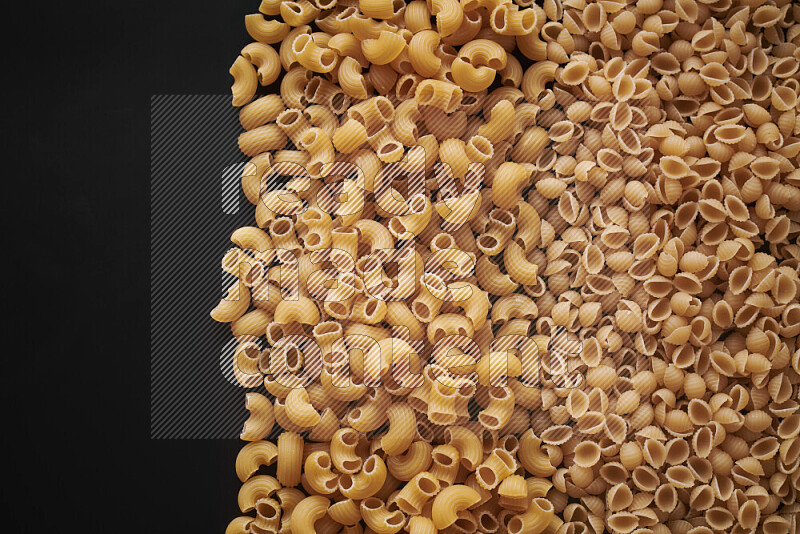 Different pasta types on black background