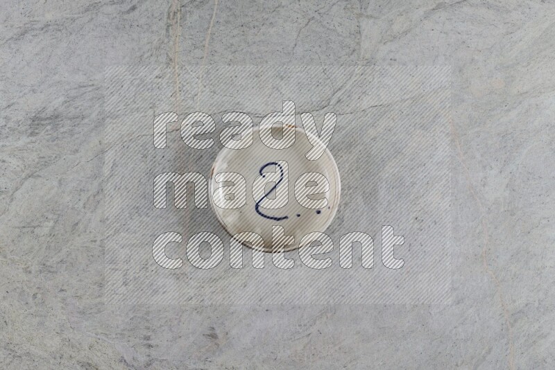 A multicolored pottery Bowl on grey marble background
