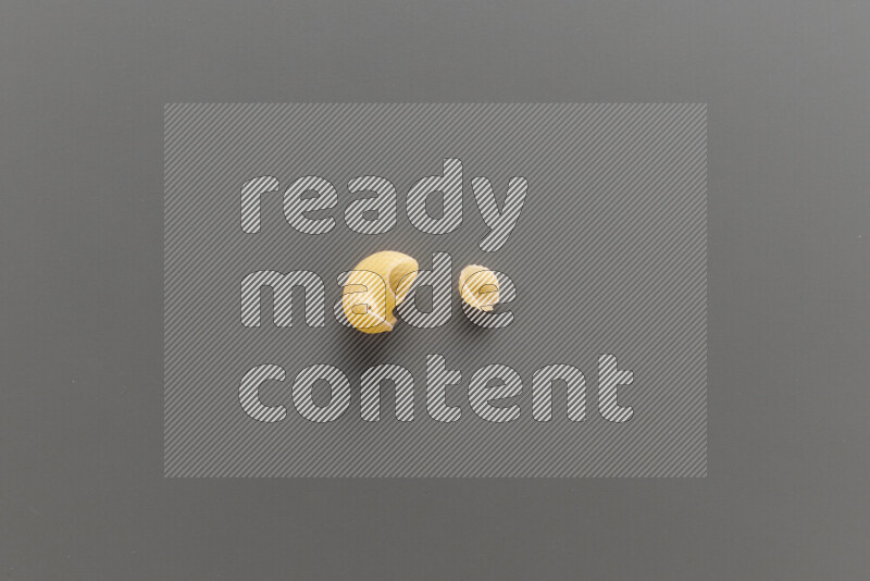 Pipe pasta with other types of pasta on grey background