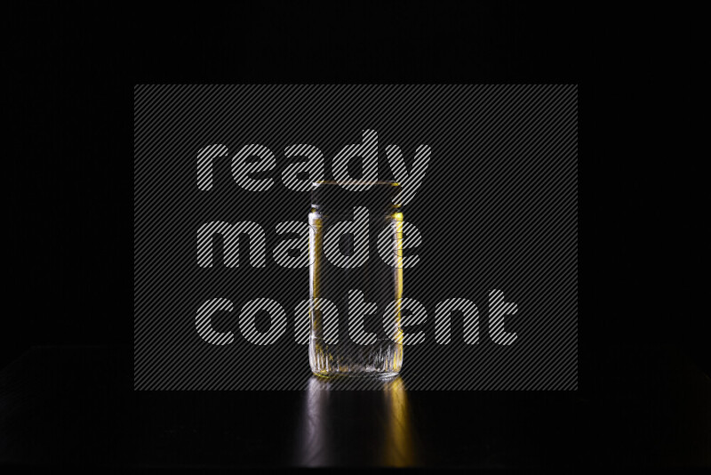 Glassware with rim light in yellow and white against black background