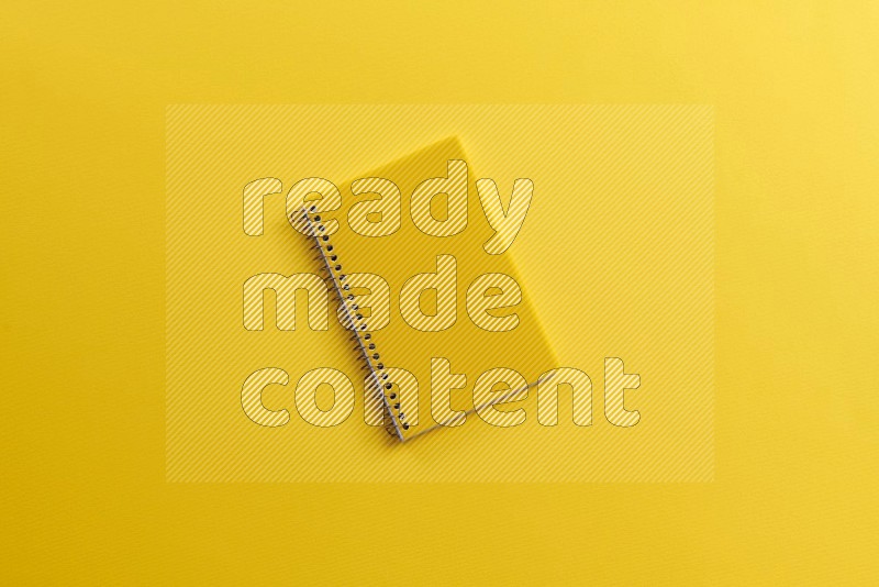 A yellow notebook on yellow background (Back to school)