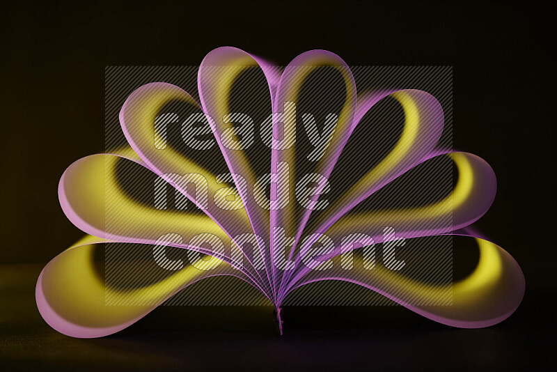 An abstract art piece displaying smooth curves in yellow and pink gradients created by colored light