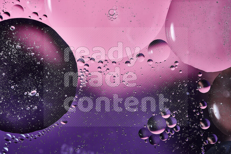 Close-ups of abstract oil bubbles on water surface in shades of purple and pink