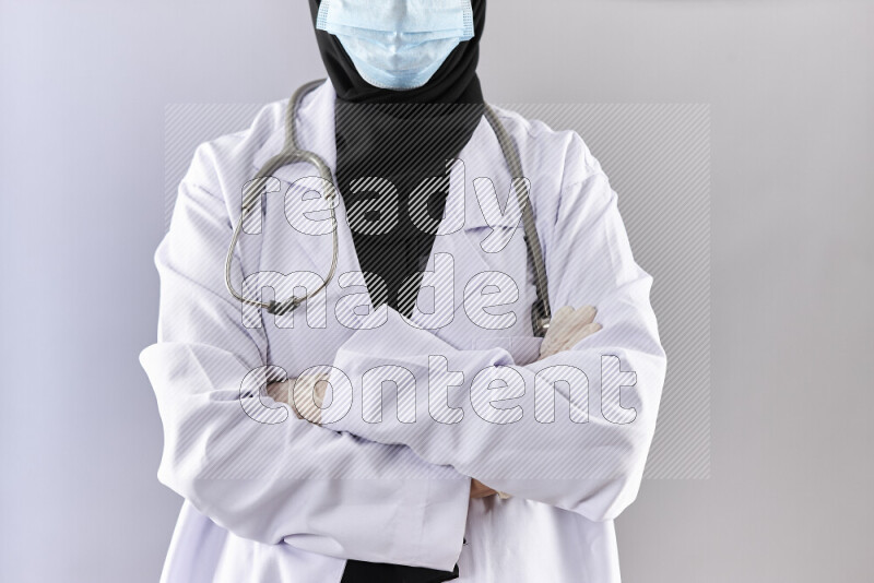 Female doctor wearing an abaya and medical attire in different positions
