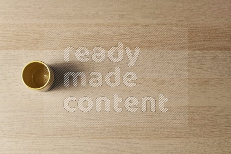 Top View Shot Of A Multicolored Pottery Cup on Oak Wooden Flooring