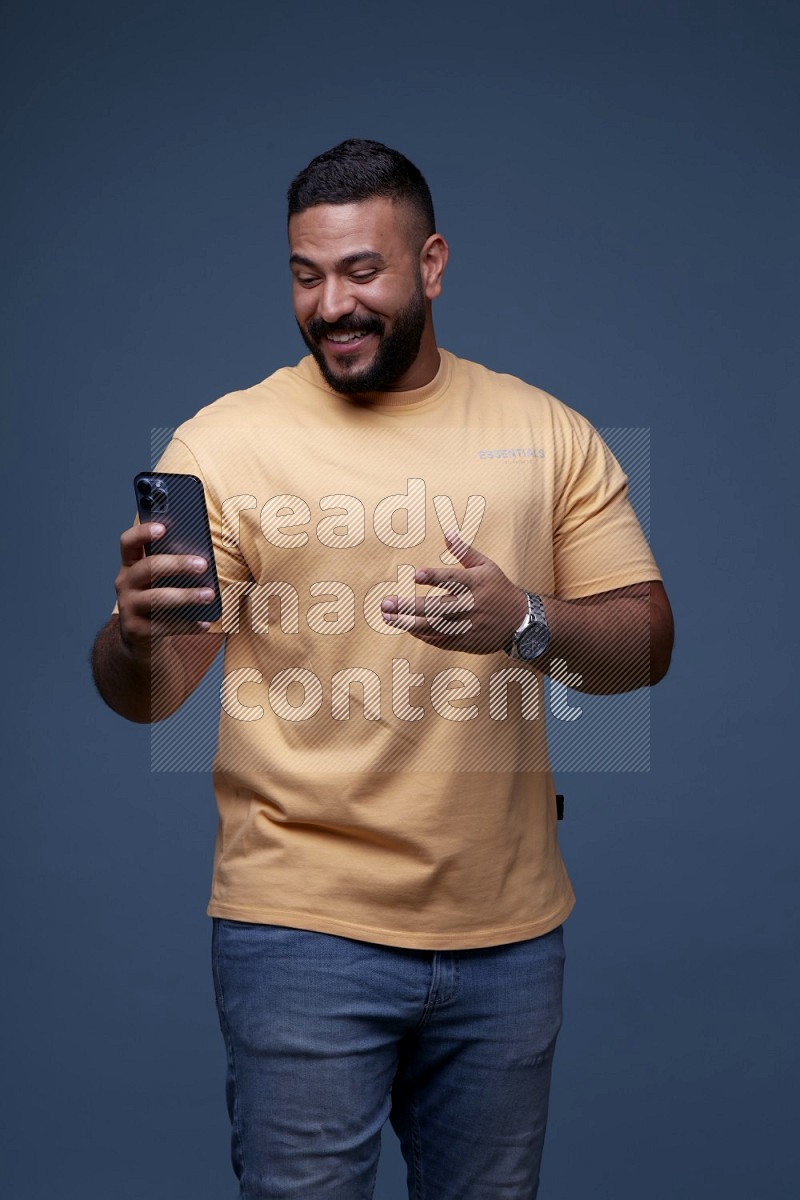 A man having a Video Calling on Blue Background wearing Orange T-shirt