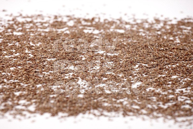 Flax seeds spread on a white flooring