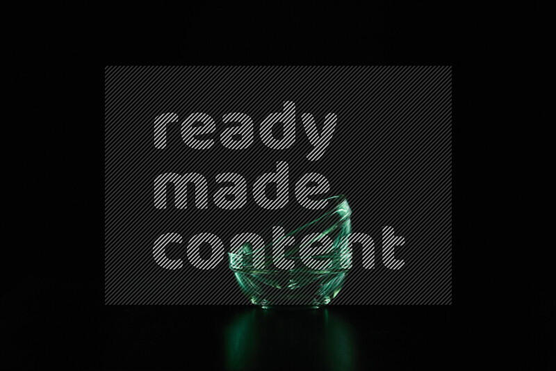 Glassware with rim light in green against black background