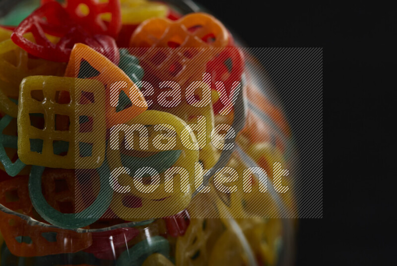 Snacks in a glass jar on black background