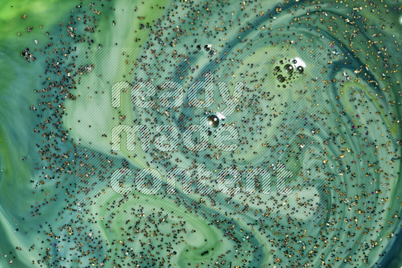 لقطة مقربة لبريق ذهبي متلألئ منتشر على خلفية من اللون الأخضر في حركات دائرية