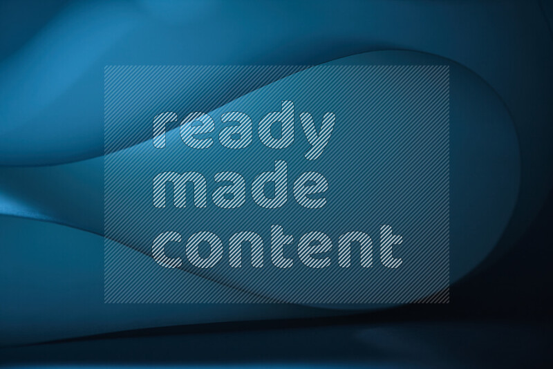 An abstract art piece displaying smooth curves in blue gradients created by colored light