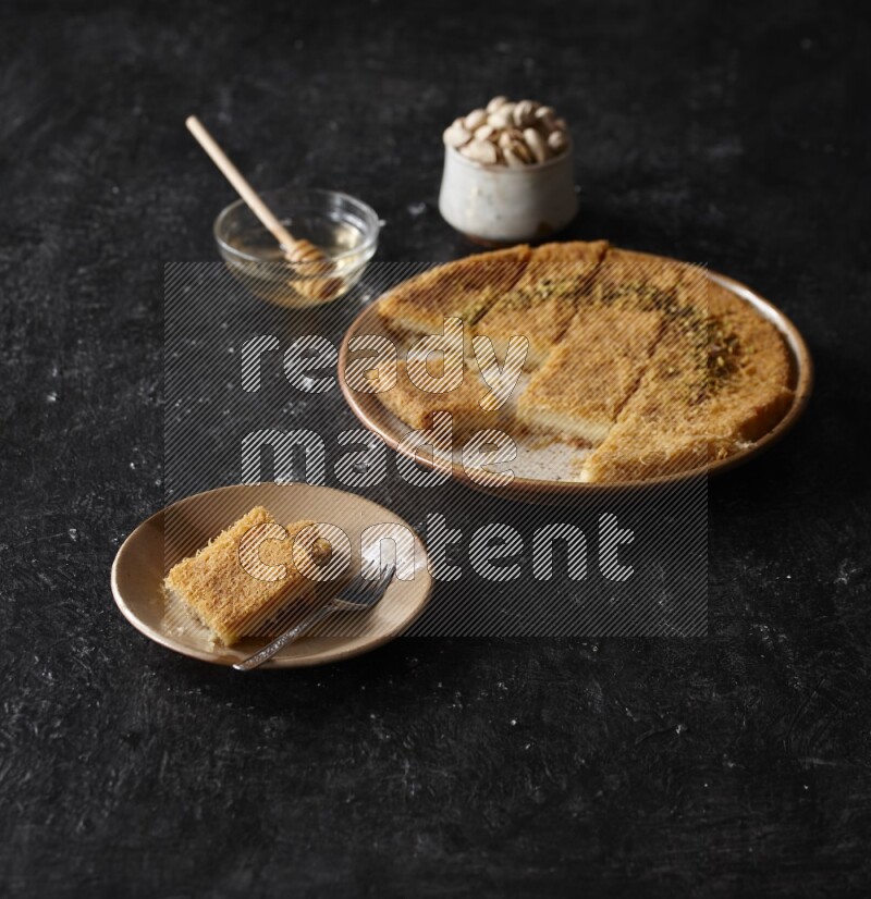 Konafa with nuts and honey in a dark setup
