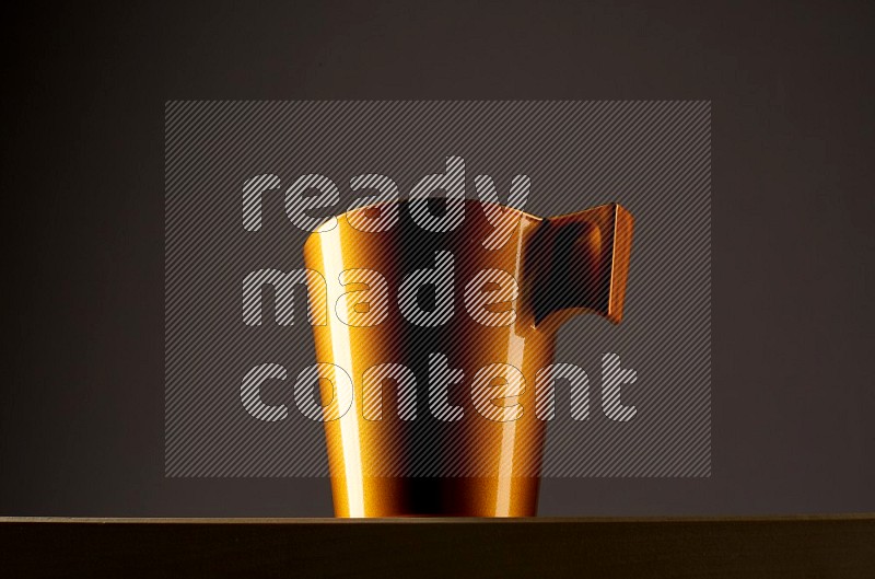 Low angle shot of a golden cup on grey background