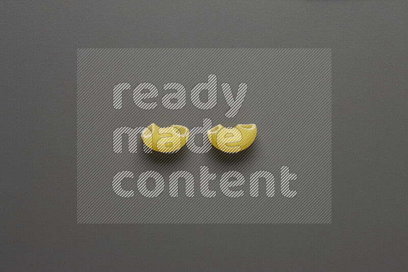 Elbow pasta on grey background