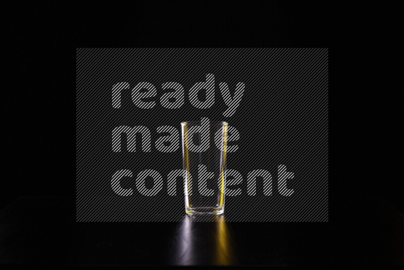 Glassware with rim light in yellow and white against black background