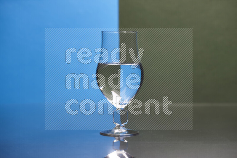 The image features a clear glassware filled with water, set against blue and dark green background