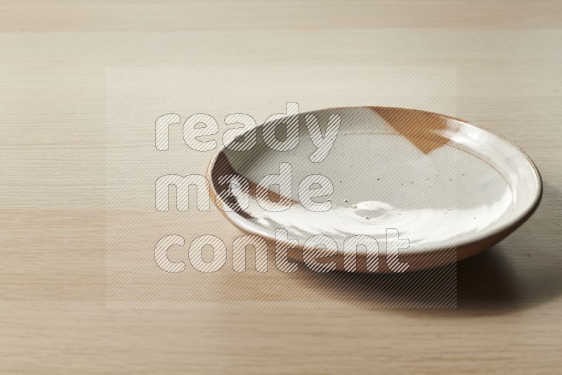 Multicolored Pottery Plate on Oak Wooden Flooring, 15 degrees