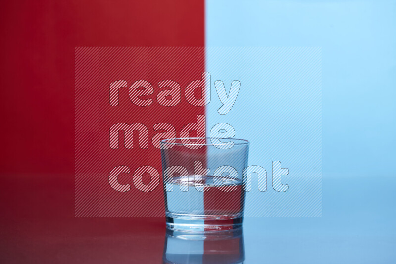 The image features a clear glassware filled with water, set against red and light blue background