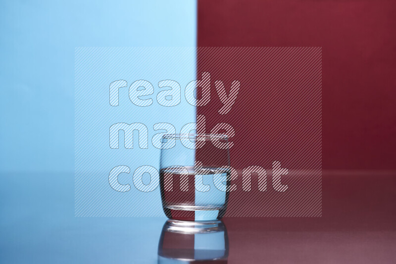 The image features a clear glassware filled with water, set against light blue and dark red background