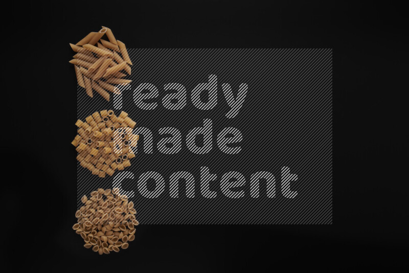 Different pasta types in 3 bunches on black background