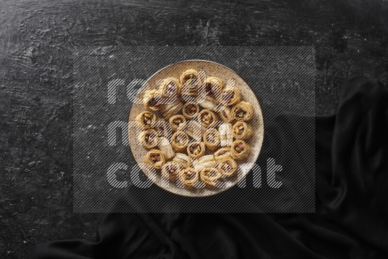 Oriental sweets in pottery plates in a dark setup