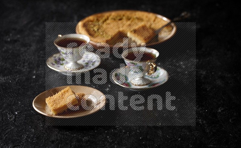 konafa with tea in a dark setup