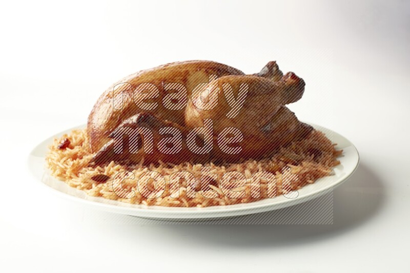 red basmati Rice with  whole roasted chicken on a white rounded plate  direct  on white background