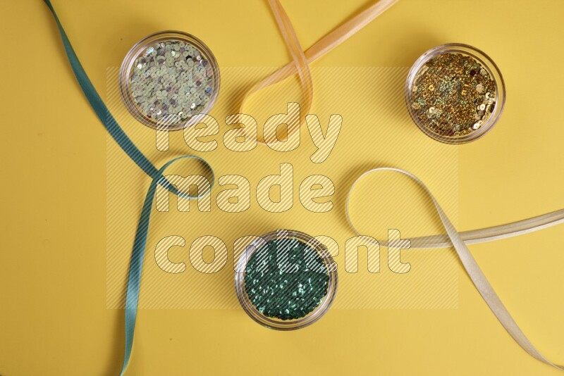 A green collection of sewing and tailoring tools arranged on a yellow background