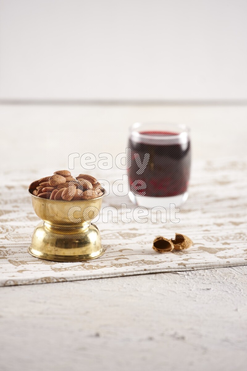 Nuts in a metal bowl with hibiscus in a light setup
