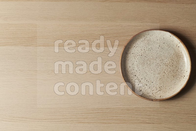 Top View Shot Of A Multicolored Pottery Plate on Oak Wooden Flooring