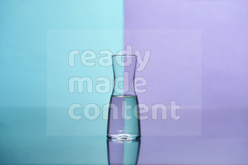 The image features a clear glassware filled with water, set against light blue and light purple background