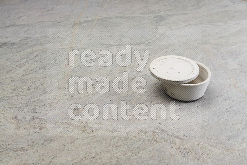 White Pottery Bowl On Grey Marble Flooring