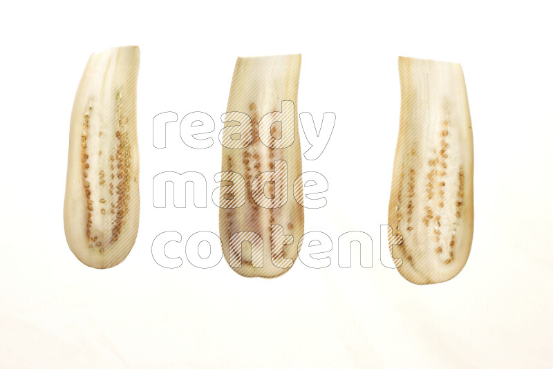 Eggplant slices on illuminated white background