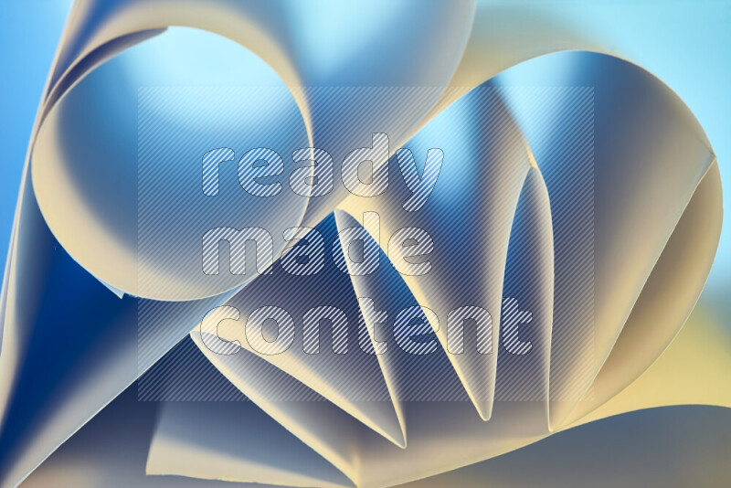 An artistic display of paper folds creating a harmonious blend of geometric shapes, highlighted by soft lighting in blue and warm tones