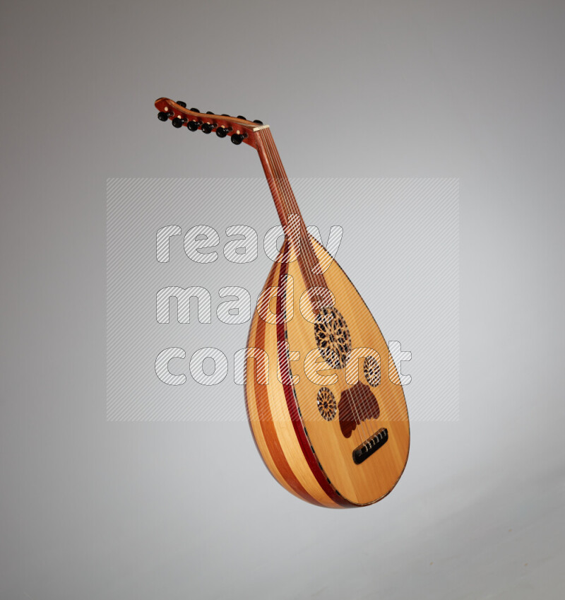 a wooden brown Oud on a gray background