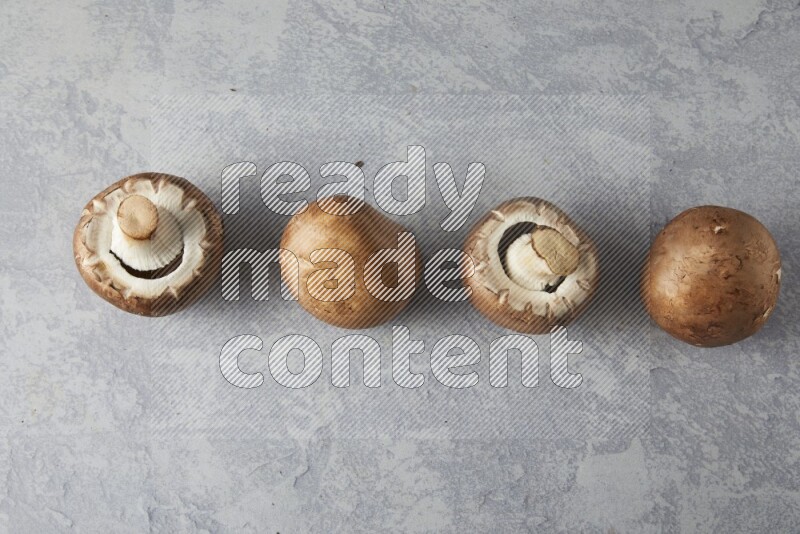 small fresh Cremini mushrooms topview on light blue background