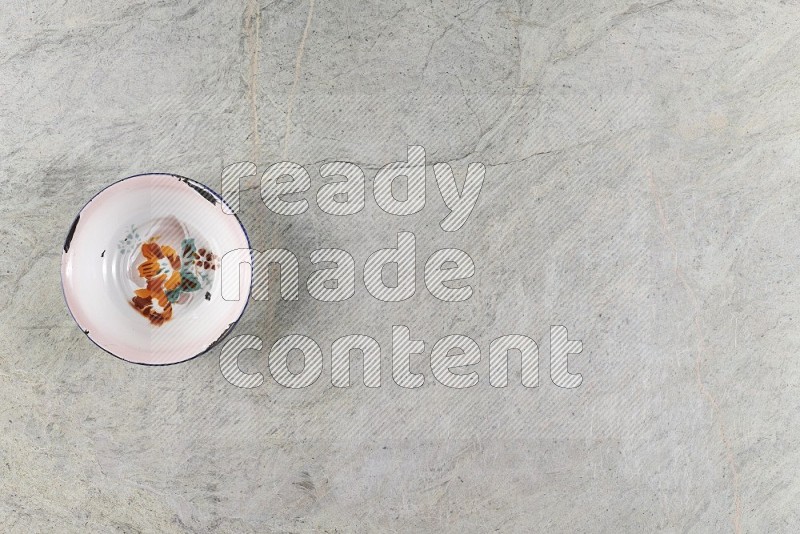 Top View Shot Of A Vintage Metal Plate On Grey Marble Flooring