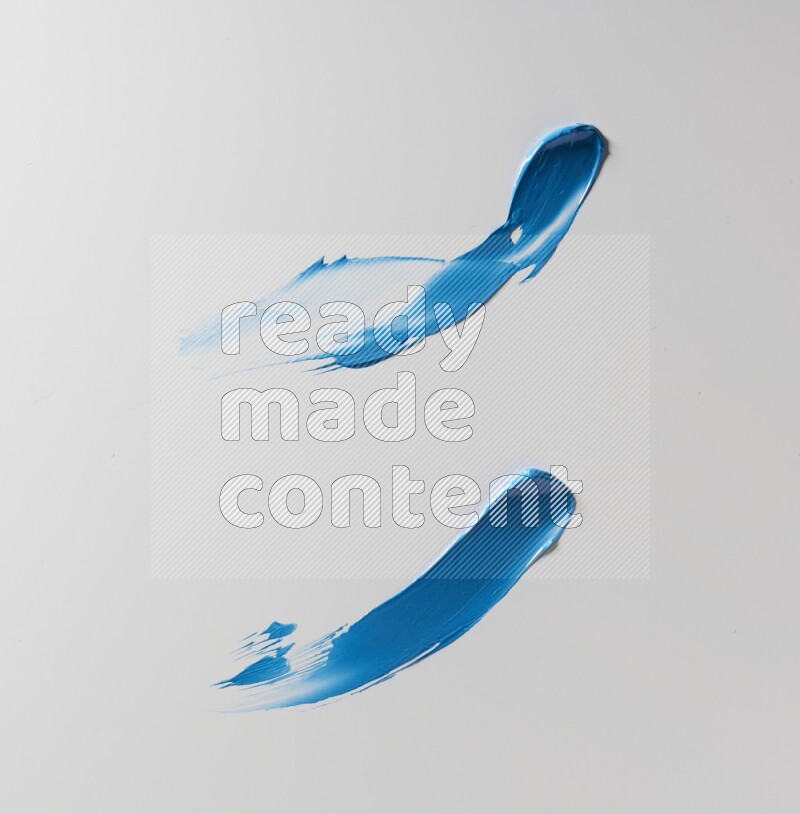 Blue curved painting knife strokes on white background