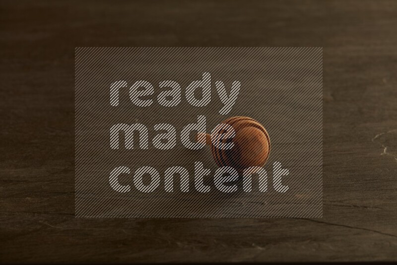 Wooden honey dipper on black slate background