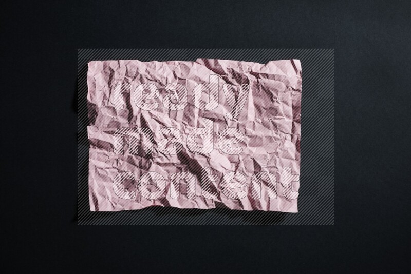 Pink paper sheet on black background