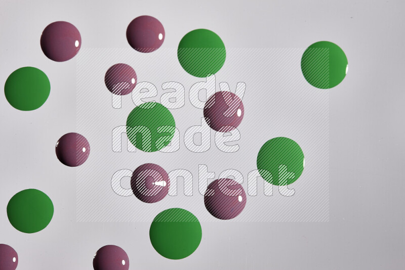Close-ups of abstract purple and green paint droplets on the surface