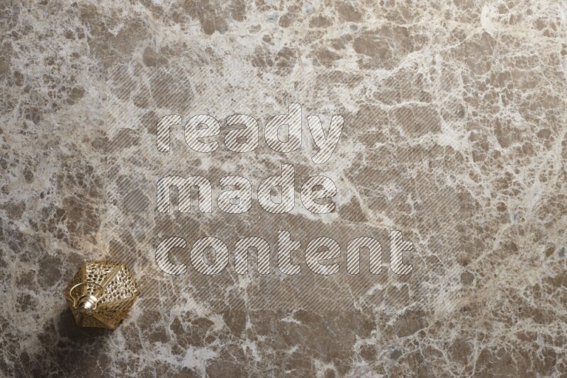 A lantern placed on a beige marble background