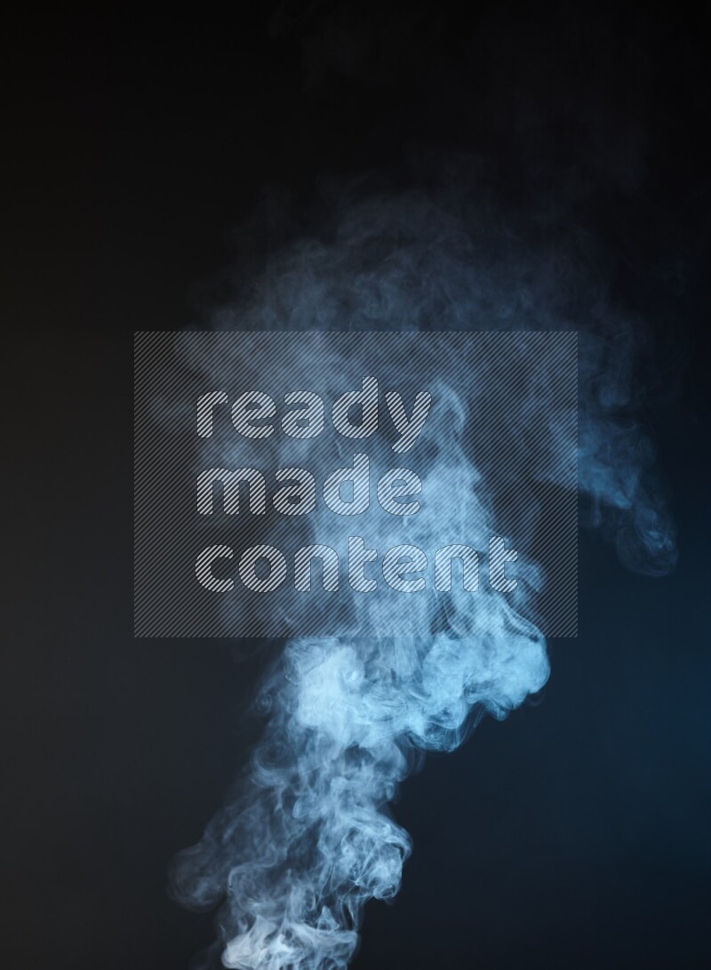 Heavy smoke in blue isolated on black background