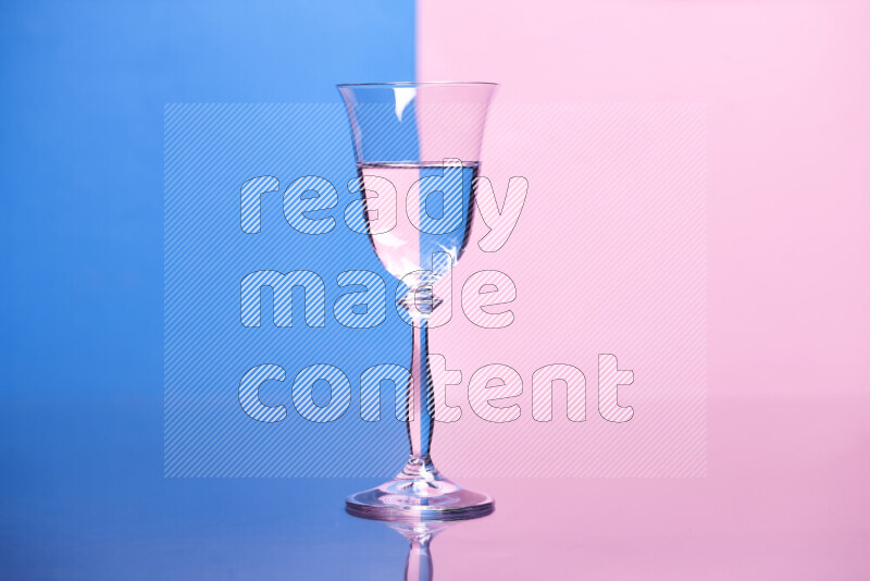 The image features a clear glassware filled with water, set against blue and rose background