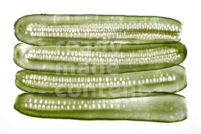 Cucumber slices on illuminated white background