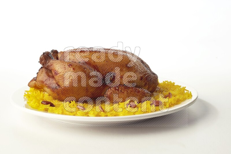 yellow  basmati Rice with  whole roasted chicken on a white rounded plate direct on white background
