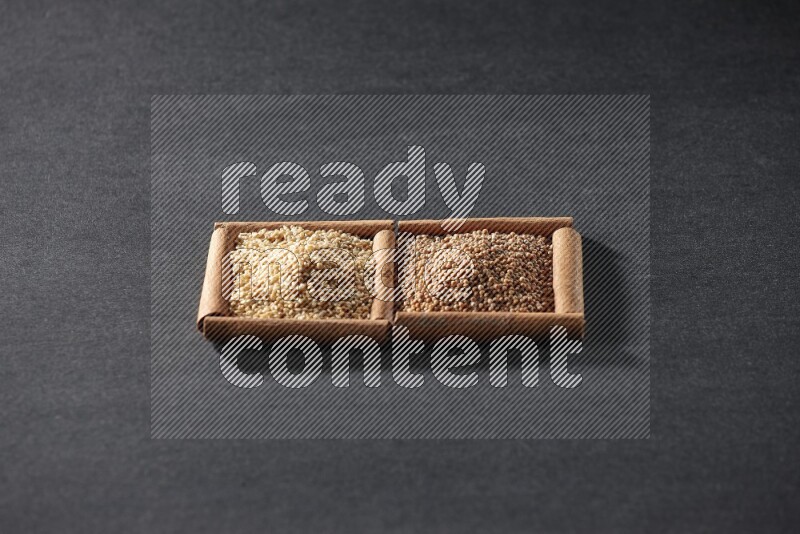 2 squares of cinnamon sticks full of mustard seeds and sesame on black flooring