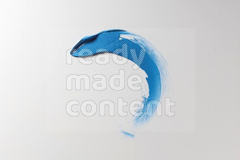 A blue single curved painting knife stroke on a white background